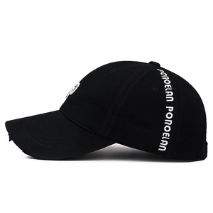 Distressed black baseball cap with white side embroidery on a white background