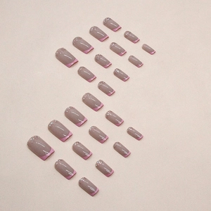 French dusty purple press-on nails with pink glitter tips in a square-oval shape