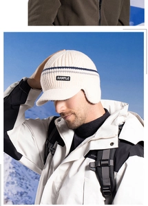 Close-up of the fleece-lined earflaps and knitting texture on a beige winter visor hat