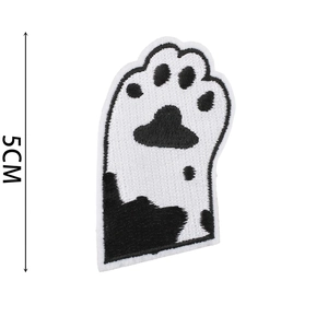 Detail view of 5x3.5cm black and white embroidered cat paw patch with size dimensions