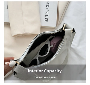 Internal view of white faux crocodile leather shoulder bag showing spacious storage capacity