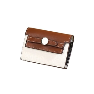 Brown and cream leather card holder with metal snap closure and visible white stitching