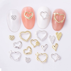Golden and silver heart-shaped alloy nail art charms with rhinestones in various styles