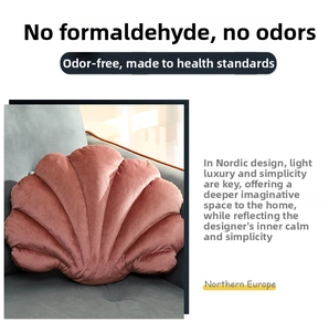Detailed view of sea shell shaped velvet pillow with soft texture and shell stitch patterns