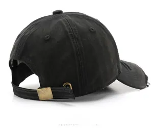 Detail of adjustable brass buckle and washed denim texture on the black baseball cap