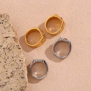 Close-up of four square vintage rings in gold and silver finish with red gemstones