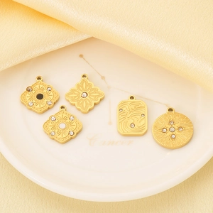 French vintage gold pendants with micro-inlaid crystals on silk background
