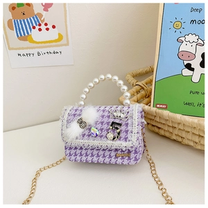 Detailed view of purple houndstooth girls bag with pearl handle and jewelry charms