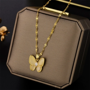 Elegant gold butterfly necklace with cat eye stone and zircon on jewelry box
