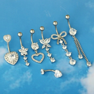 Detail view of assorted stainless steel belly rings with heart and flower zircon studs
