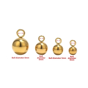 Detail view of four golden stainless steel ball pendants in sizes 8mm, 6mm, 5mm and 4mm