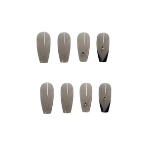 Taupe long ballerina press-on nails with glitter lines, rhinestones, and black V-cut tips