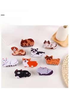 Detail view of cute animal shaped hair claw clips featuring various cats and dogs designs