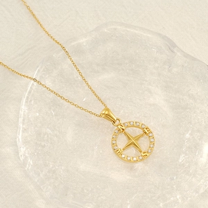 Minimalist gold compass pendant necklace with sparkling cubic zirconia and starburst design