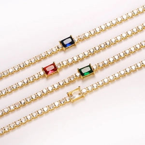 Macro view of colorful zircon tennis bracelets with rectangular center stones in gold finish