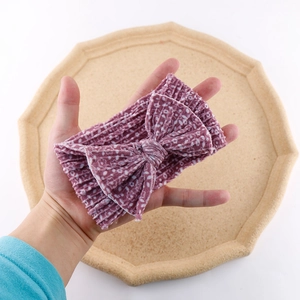 Close-up of soft purple double-layer nylon headband with large bow on a tray