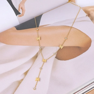 Detailed view of gold butterfly tassel necklace with sparkling rhinestones and matte finish
