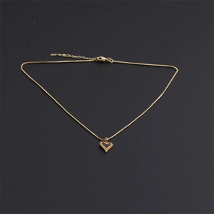 Vintage gold necklace featuring a heart pendant with a black center and zircon edges