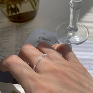Close-up of S925 silver pavé ring with shimmering zircons under striped light