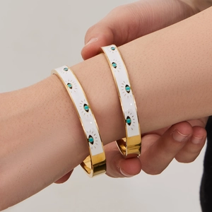 Polished 18k gold plated stainless steel bangles with white enamel and devil eye design