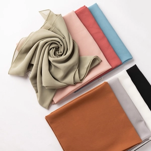 Close-up of assorted lightweight chiffon hijabs showing rolled edges and vibrant colors
