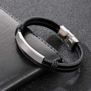 Detail of black braided leather men's bracelet with polished stainless steel clasp