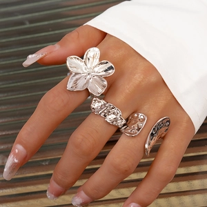 Detailed view of silver irregular geometric flower ring set with metallic molten texture