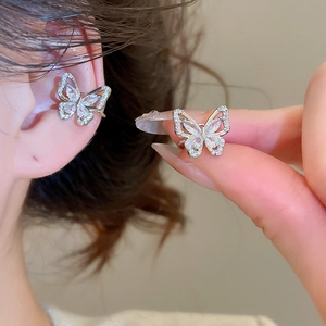 Detailed view of silver butterfly ear bone clips with sparkling zircon stones