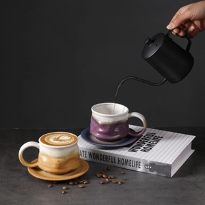 Artistic Japanese ceramic coffee cup set with hand pouring water into a purple gradient mug