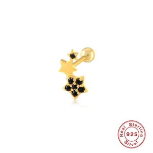 Macro detail of 925 sterling silver curved earring with gold plating and black star stones
