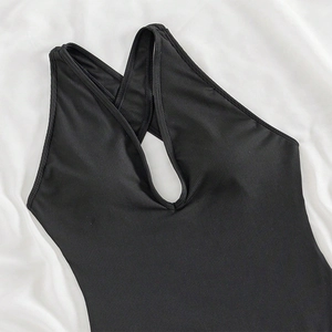 Detail of black one-piece swimsuit featuring ribbed fabric and teardrop cutout design