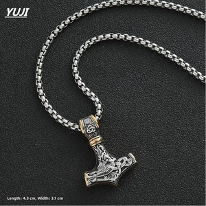 Close-up of vintage Mjolnir Thor Hammer pendant with golden Celtic knots, size 4.3x3.1cm