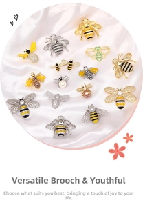 Detailed collection of 14 bee brooches with zircon and pearl on white silk background