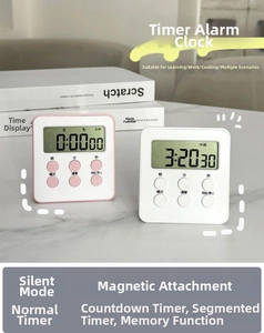 Close-up of pink and white magnetic digital timers with large LCD screens on a desk