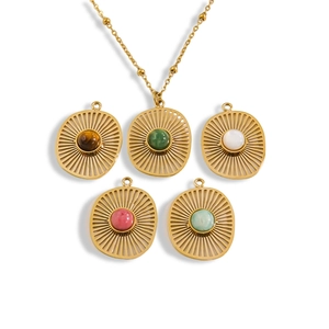 Bohemian gold sunburst necklaces set with colorful natural stones on white backdrop
