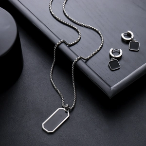 Men's stainless steel rectangle pendant necklace and earrings set on black tray