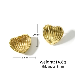 Detailed view of gold heart earrings showing 3D ribbed texture and 29mm size dimensions