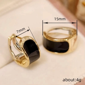 Minimalist gold and black enamel C-shaped hoop earrings with 15mm diameter and 7mm width
