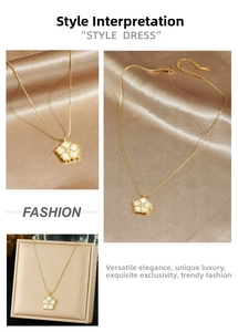 Detailed views of a gold flower pendant necklace with white shell inlay and center diamond