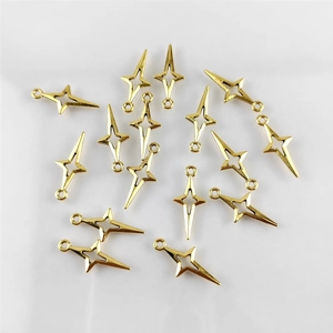 Flat lay macro of golden four-point star alloy pendants for DIY jewelry making accessories