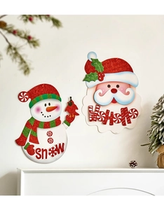 Detail of Christmas wall decorations featuring snowman and Santa on a white fireplace background