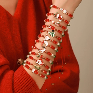 Set di 12 braccialetti natalizi con ciondoli Babbo Natale e albero su cordino rosso