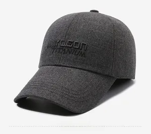 Detail of embroidered logo on dark grey wool blend baseball cap with ear flaps