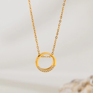 Minimalist gold-plated stainless steel necklace featuring a crystal geometric ring pendant