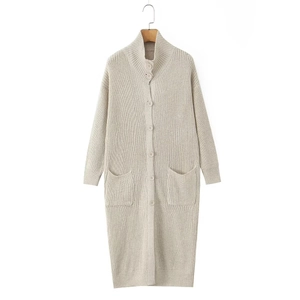 Women's long beige chunky knit cardigan with buttons and pockets in a clean studio view