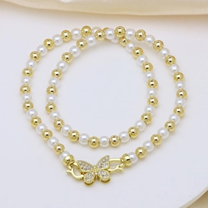 Macro shot of pearl necklace with a sparkling gold butterfly clasp encrusted with crystals