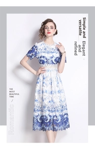 Close-up of elegant hollow-out lace fabric with gradient blue and white floral printing