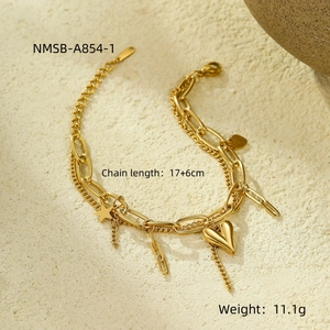 Close-up of golden double-layer chain bracelet with heart, star, and rectangular charms