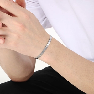 Sleek silver stainless steel snake chain bracelet for men and women on model's wrist