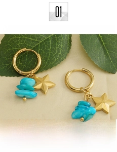 Detail of 18k gold plated titanium steel earrings with turquoise stones and star charms